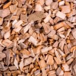 Ágdarálás Detailed close-up shot of natural wooden chips, showcasing texture and earthy tones.