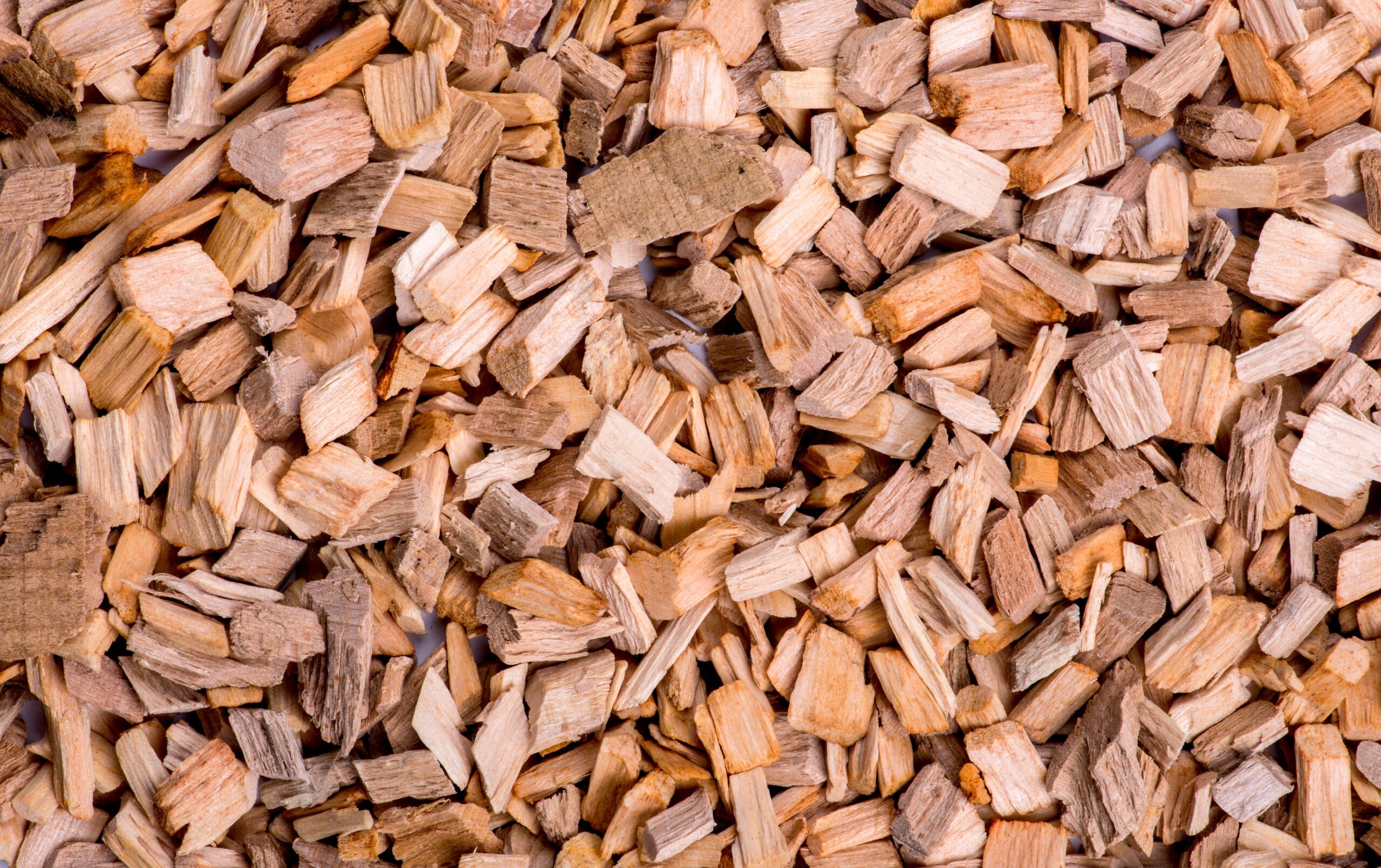 Detailed close-up shot of natural wooden chips, showcasing texture and earthy tones.